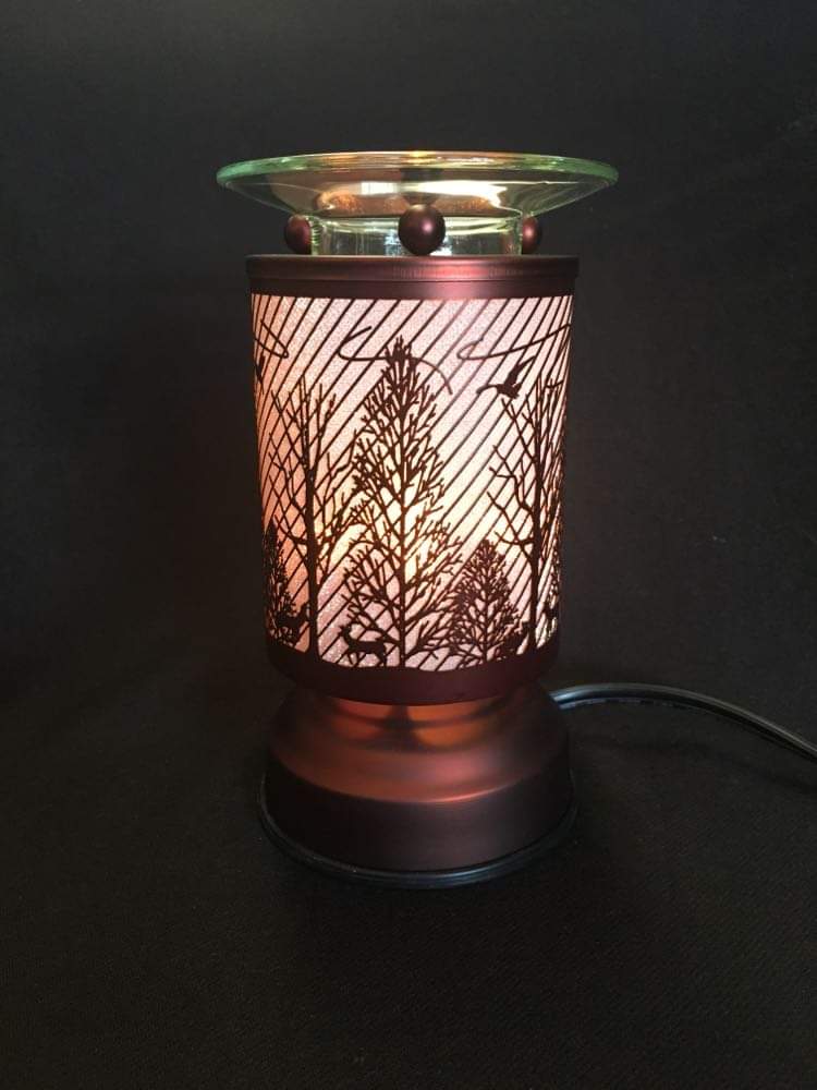 small bronze touch lamp with trees and birds and a wax melt holder